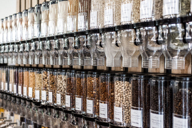 Rows of clear bulk-food dispensers filled with pantry ingredients